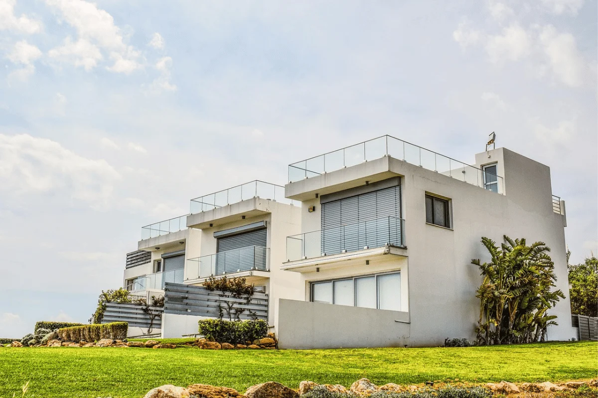 Modern white duplex homes with glass balconies.