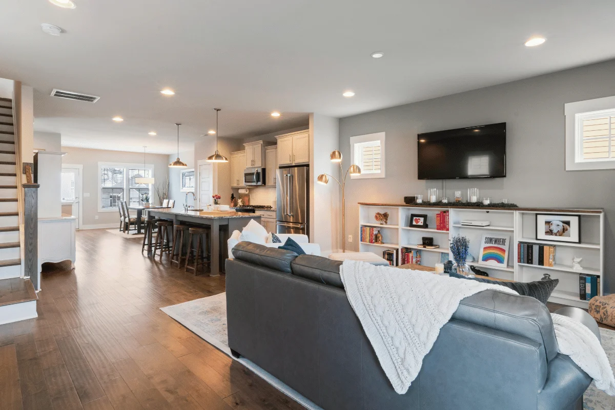 Modern open-concept living area with kitchen, island seating, and cozy family room décor.